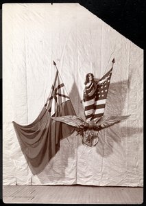 Ein lebendes Bild: ein Modell, das in die amerikanische Flagge gehüllt ist und auf einer Skulptur eines Weißkopfseeadlers steht, 1900 oder 1901 von Byron Company